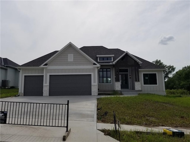 4576 Aspen Dr, Basehor, KS 66007 - view of front of home featuring an attached garage, stone siding, board and batten siding, and concrete driveway