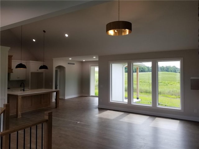 4576 Aspen Dr, Basehor, KS 66007 - unfurnished living room with arched walkways, high vaulted ceiling, wood finished floors, and recessed lighting