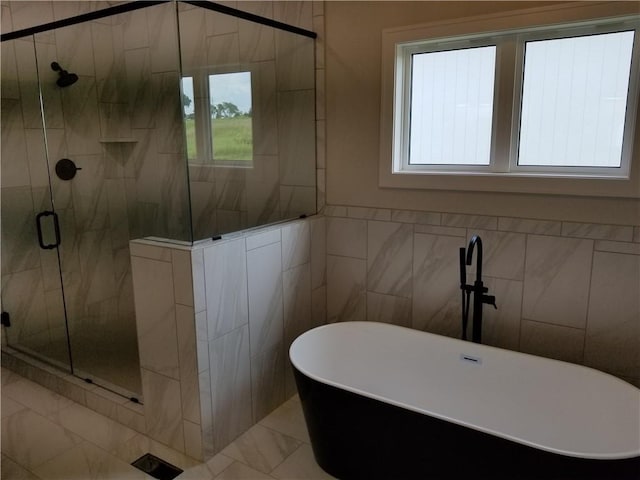 4576 Aspen Dr, Basehor, KS 66007 - full bathroom with a freestanding bath, a stall shower, and tile walls