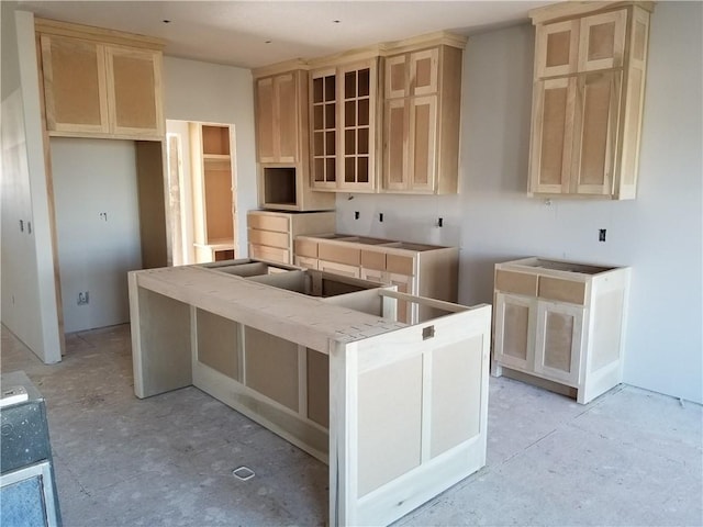 kitchen with a center island and light brown cabinets