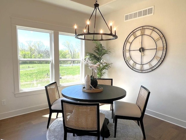 dining room with an inviting chandelier and dark hardwood / wood-style flooring