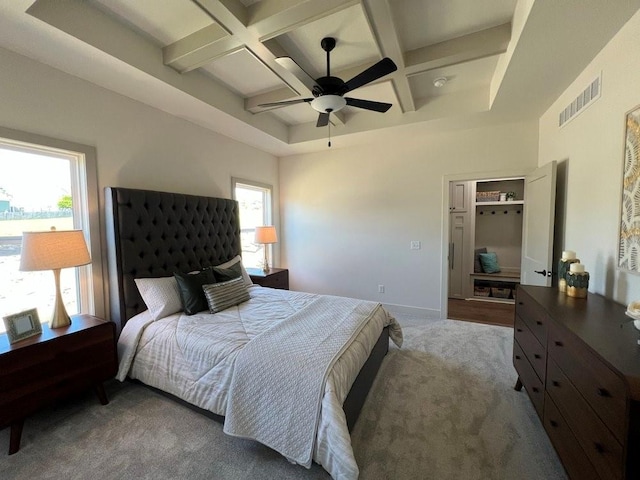 carpeted bedroom featuring ceiling fan, coffered ceiling, and beam ceiling