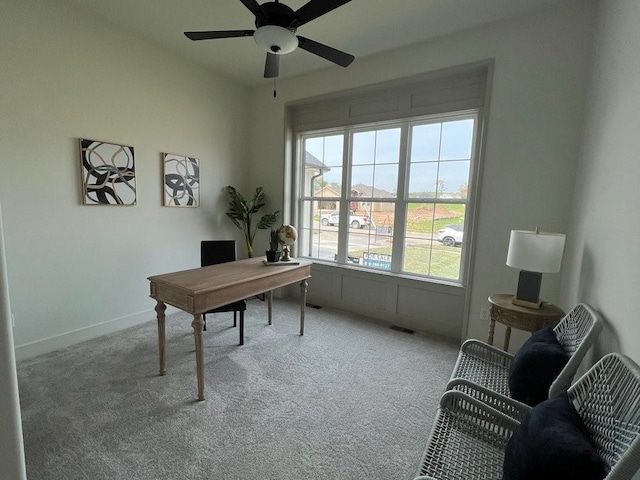 carpeted home office with ceiling fan