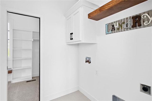 clothes washing area featuring washer hookup, cabinet space, visible vents, hookup for an electric dryer, and baseboards