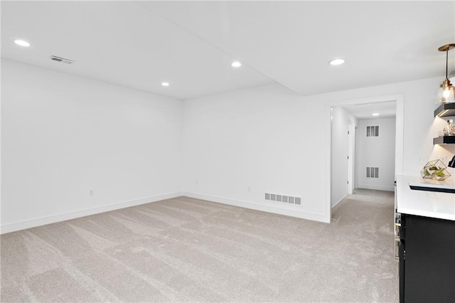 spare room with light carpet and visible vents