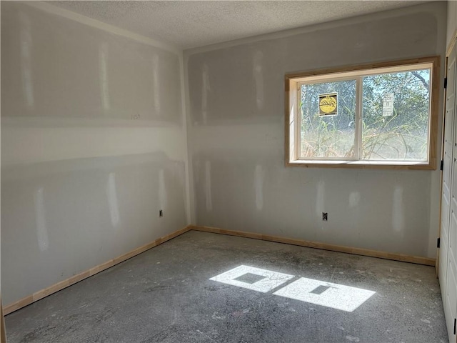 empty room featuring a textured ceiling