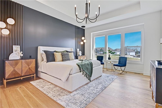 17433 Gillette St, Overland Park, KS 66221 - bedroom featuring wood-type flooring, a chandelier, and a raised ceiling
