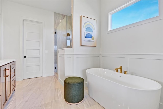 17433 Gillette St, Overland Park, KS 66221 - bathroom featuring a stall shower, vanity, a decorative wall, a freestanding tub, and marble finish floors