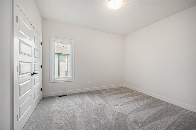 unfurnished room with carpet flooring