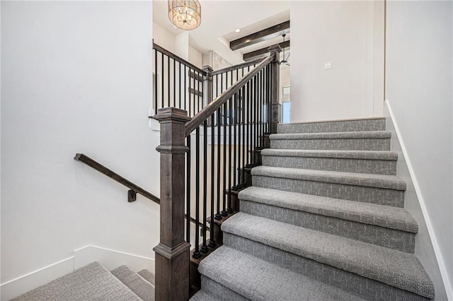 staircase with beamed ceiling