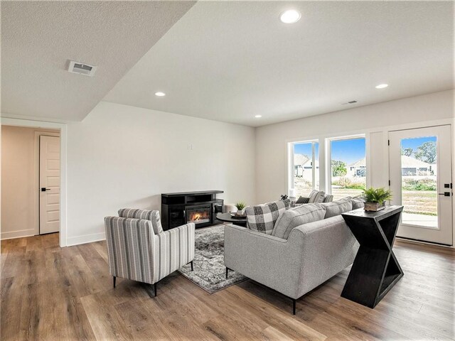 living room featuring hardwood / wood-style flooring and a textured ceiling