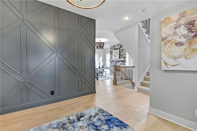 entryway featuring hardwood / wood-style flooring and an inviting chandelier