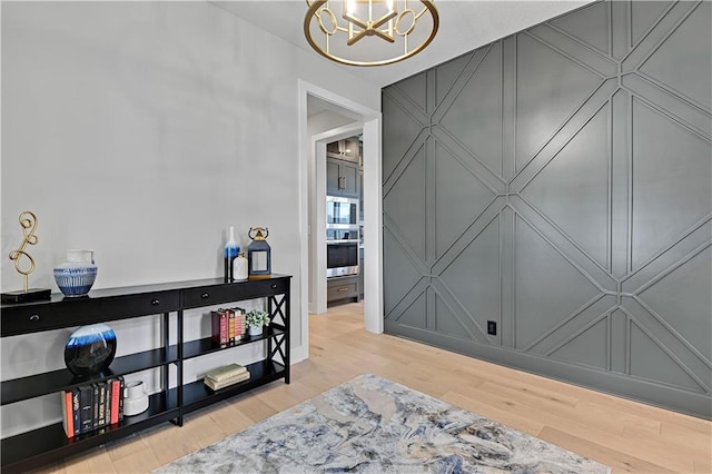 interior space featuring light hardwood / wood-style floors and an inviting chandelier