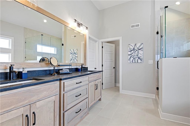 bathroom with vanity, tile patterned floors, and an enclosed shower