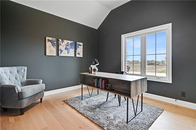 office space featuring light wood-type flooring and vaulted ceiling