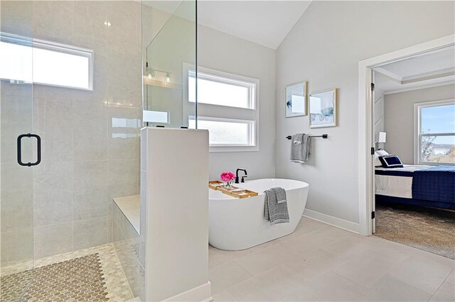 17421 Gillette St, Overland Park, KS 66221 - bathroom with a walk in shower, a soaking tub, ensuite bath, vaulted ceiling, and baseboards