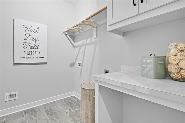 17421 Gillette St, Overland Park, KS 66221 - laundry area featuring hookup for an electric dryer, cabinet space, baseboards, light marble finish floors, and washer hookup
