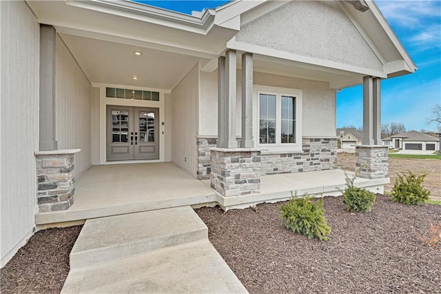 17421 Gillette St, Overland Park, KS 66221 - view of exterior entry with stone siding, covered porch, and french doors