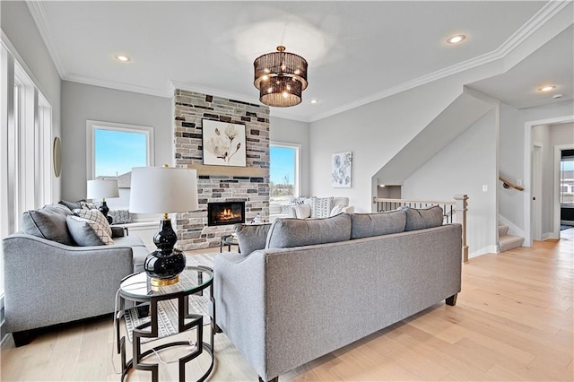 17421 Gillette St, Overland Park, KS 66221 - living room featuring plenty of natural light, light wood finished floors, a fireplace, ornamental molding, and recessed lighting