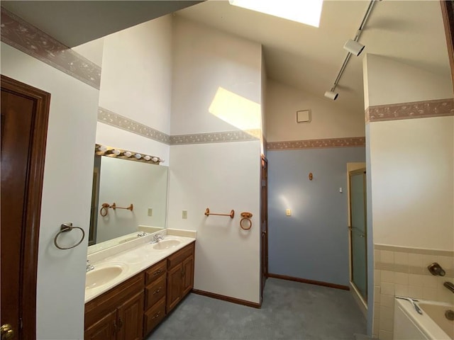 bathroom with double vanity, a shower with shower door, a sink, rail lighting, and a bath