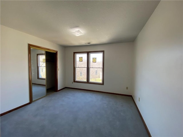 spare room featuring baseboards and a wealth of natural light