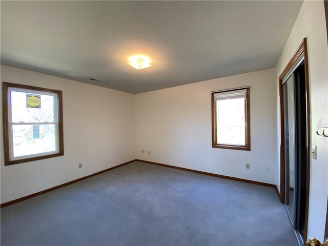 interior space featuring carpet flooring, visible vents, and baseboards