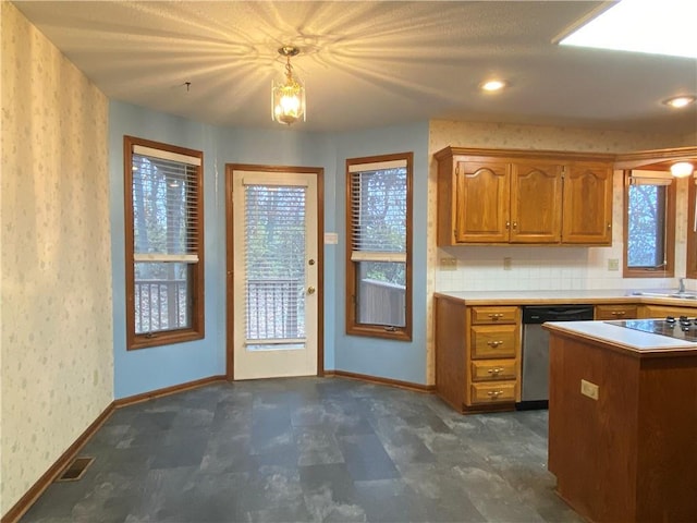 interior space featuring visible vents, stainless steel dishwasher, a wealth of natural light, and brown cabinets