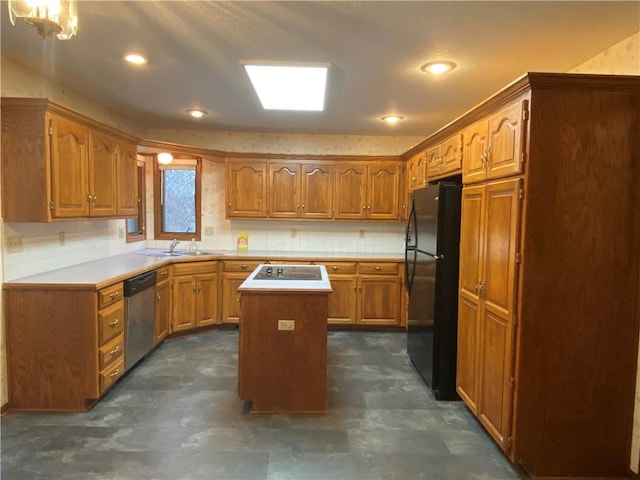 kitchen with a sink, a center island, light countertops, brown cabinets, and black appliances