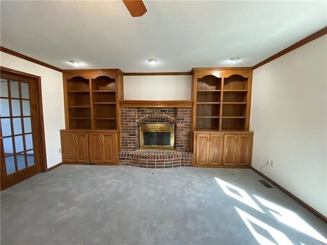 unfurnished living room featuring crown molding, carpet flooring, a fireplace, and baseboards