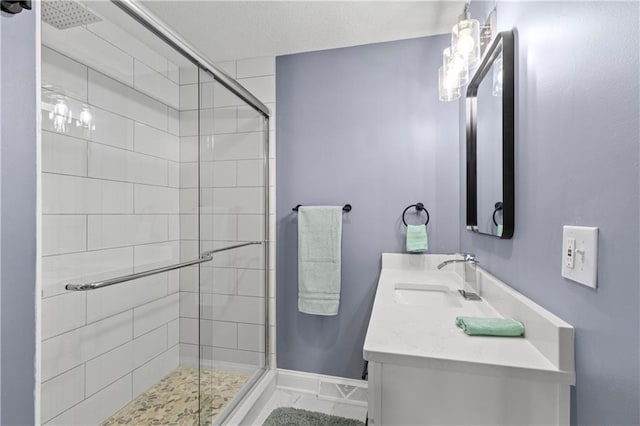 bathroom with double vanity, tile floors, and a shower with shower door