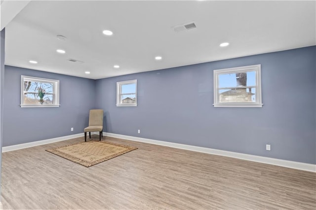 unfurnished room featuring light wood-type flooring and a wealth of natural light