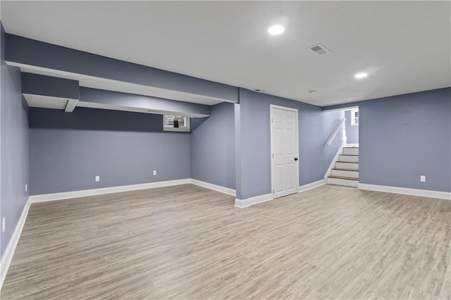 basement with light hardwood / wood-style floors