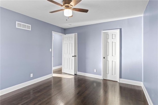 empty room with ceiling fan and dark wood-type flooring