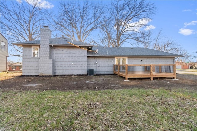 back of property featuring a deck and central AC