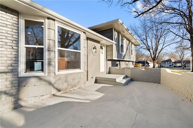 view of property exterior with a patio area