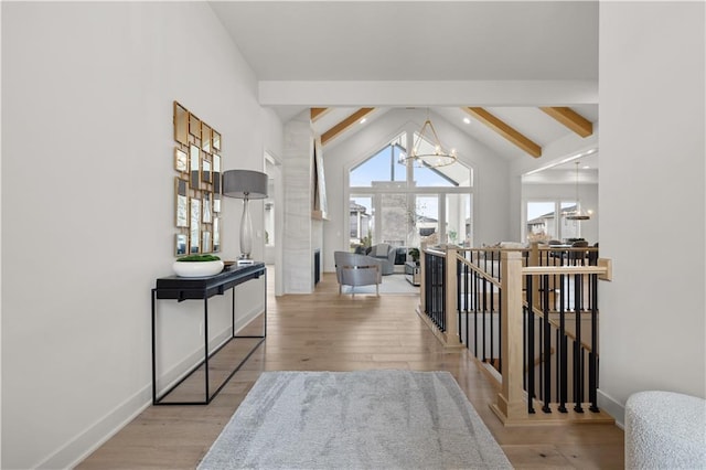 corridor featuring vaulted ceiling with beams, a chandelier, and light wood-type flooring