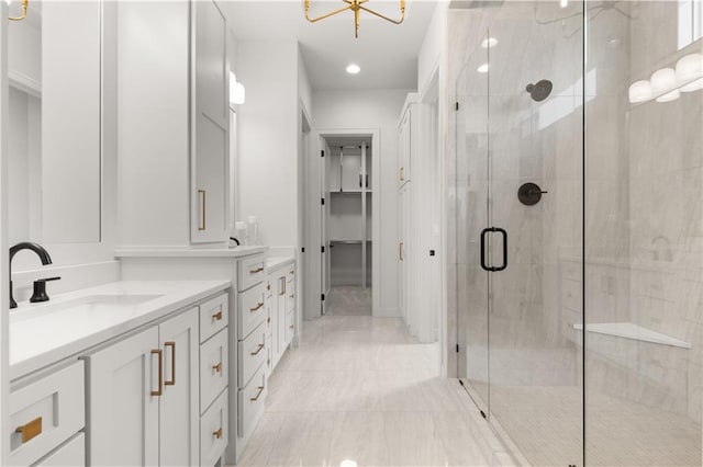 bathroom with a shower with door and vanity