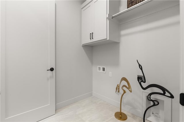 clothes washing area featuring cabinets and hookup for a washing machine