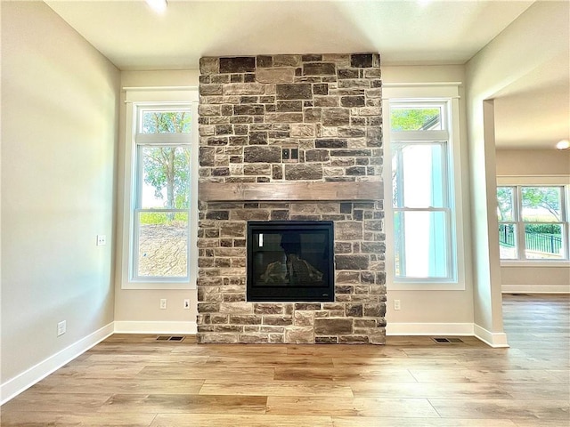 interior details with wood-type flooring and a fireplace