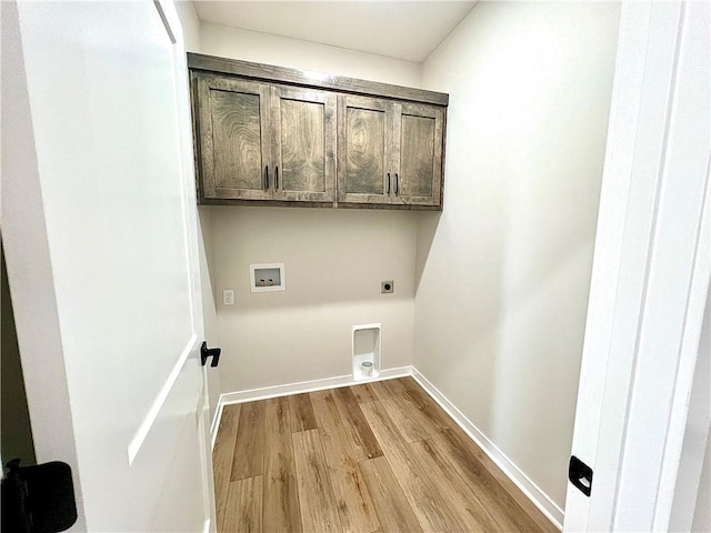 washroom featuring light hardwood / wood-style floors, hookup for a washing machine, cabinets, and hookup for an electric dryer