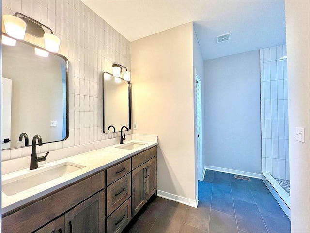 bathroom with walk in shower, vanity, tile walls, and tile patterned floors