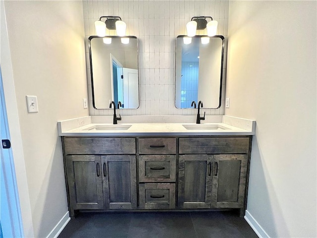 bathroom featuring tile patterned flooring, decorative backsplash, and vanity