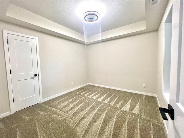 carpeted spare room featuring a textured ceiling