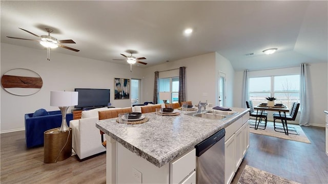 kitchen with dishwasher, sink, a healthy amount of sunlight, a center island with sink, and white cabinets