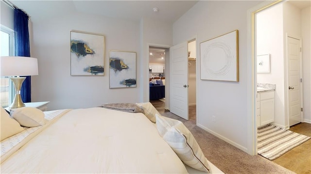 carpeted bedroom featuring ensuite bathroom