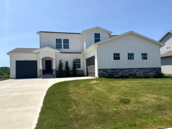 29613 W 196th St, Gardner, KS 66030 - view of front facade with an attached garage, board and batten siding, a front yard, and driveway