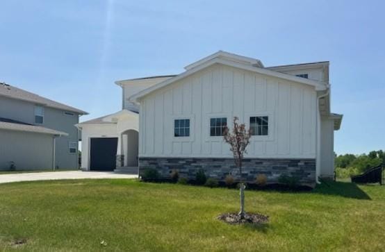 29613 W 196th St, Gardner, KS 66030 - view of front of home featuring board and batten siding, concrete driveway, an attached garage, and a front lawn
