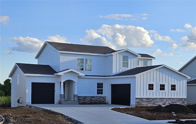29613 W 196th St, Gardner, KS 66030 - view of front of home featuring concrete driveway, a garage, board and batten siding, stone siding, and a shingled roof