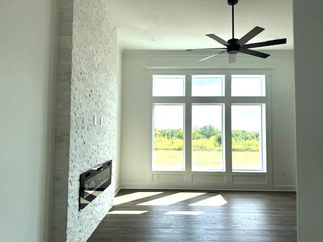29613 W 196th St, Gardner, KS 66030 - unfurnished living room featuring ceiling fan, a fireplace, wood finished floors, and baseboards