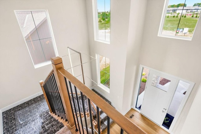 staircase with a towering ceiling